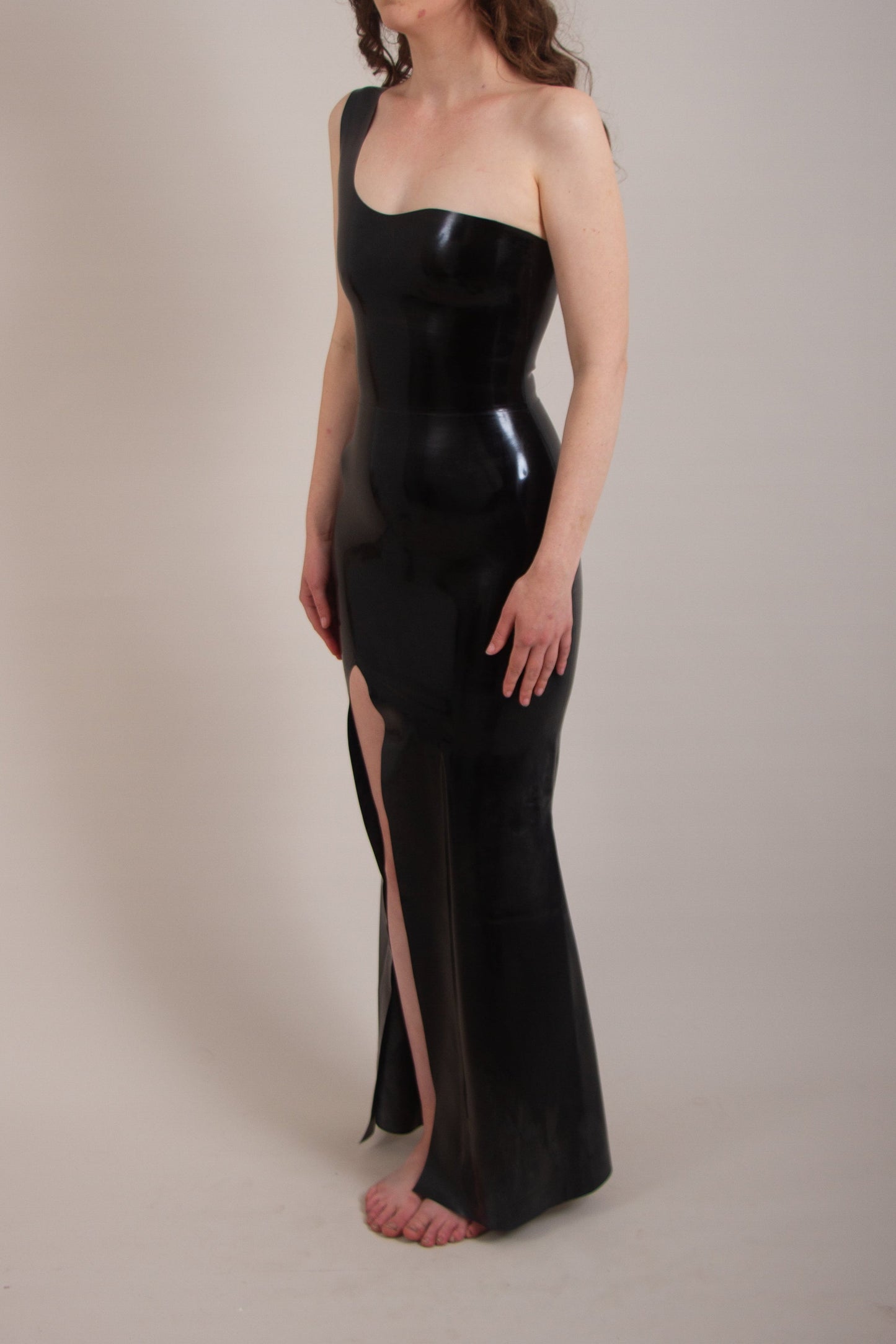 One shoulder high-shine latex dress with thigh-high slit, fitted bodice, and floor-length skirt