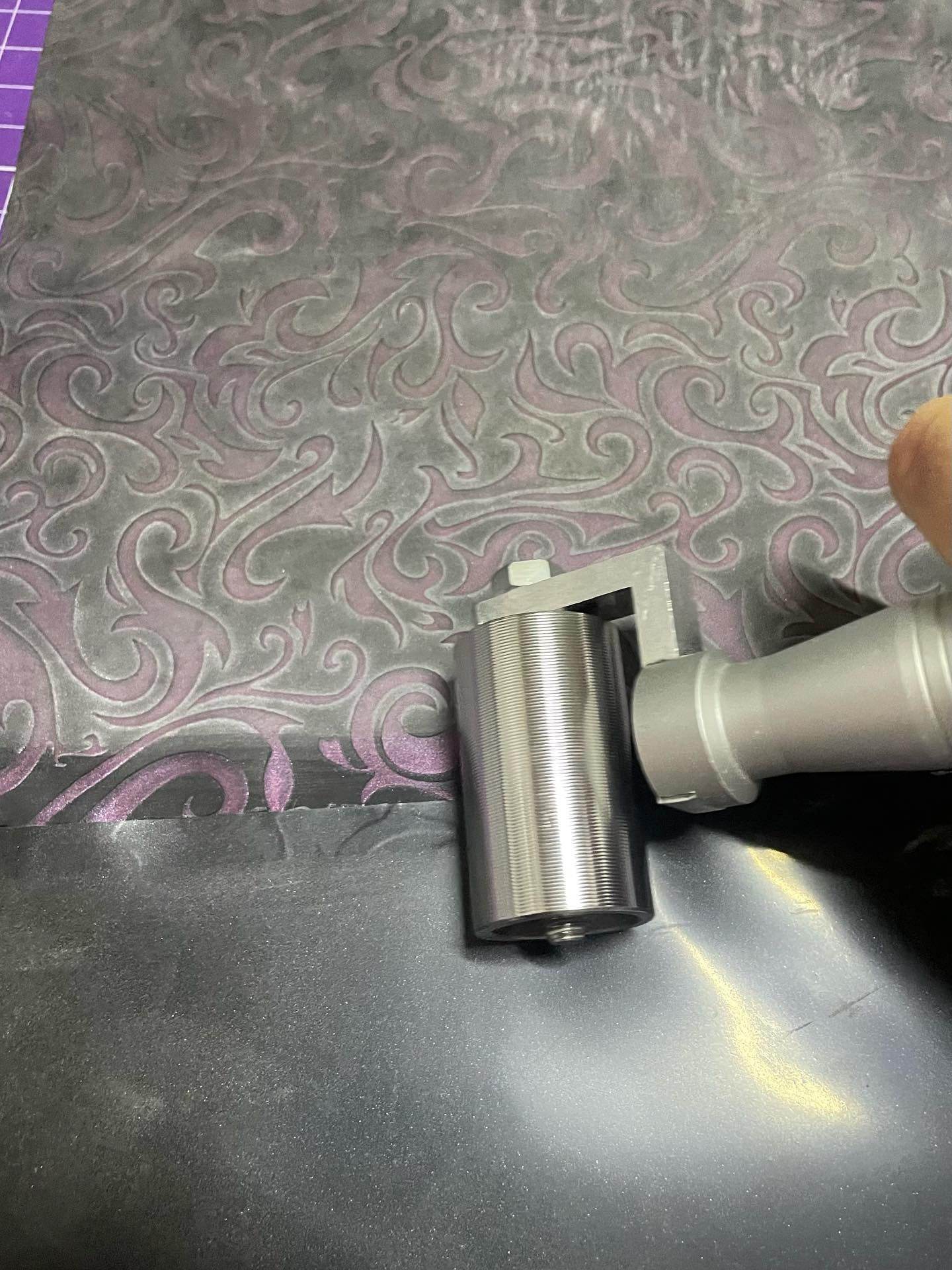 Latex seam roller with stainless steel head and textured handle rolling glued latex seams smoothly and securely